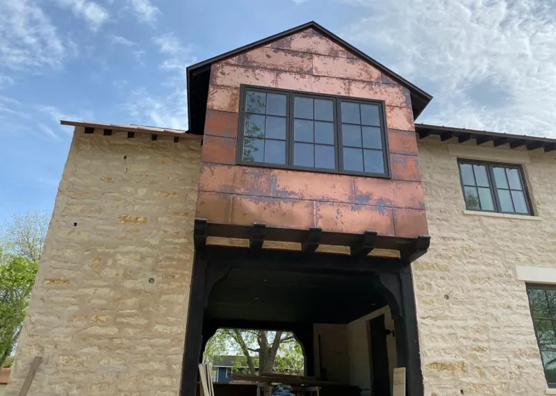 Copper metal panel facade on a stone building for Skylight Installation in Perry
